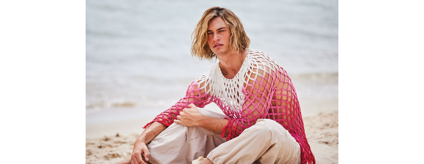 Model showcasing healthy colour-treated hairstyle by the sea.